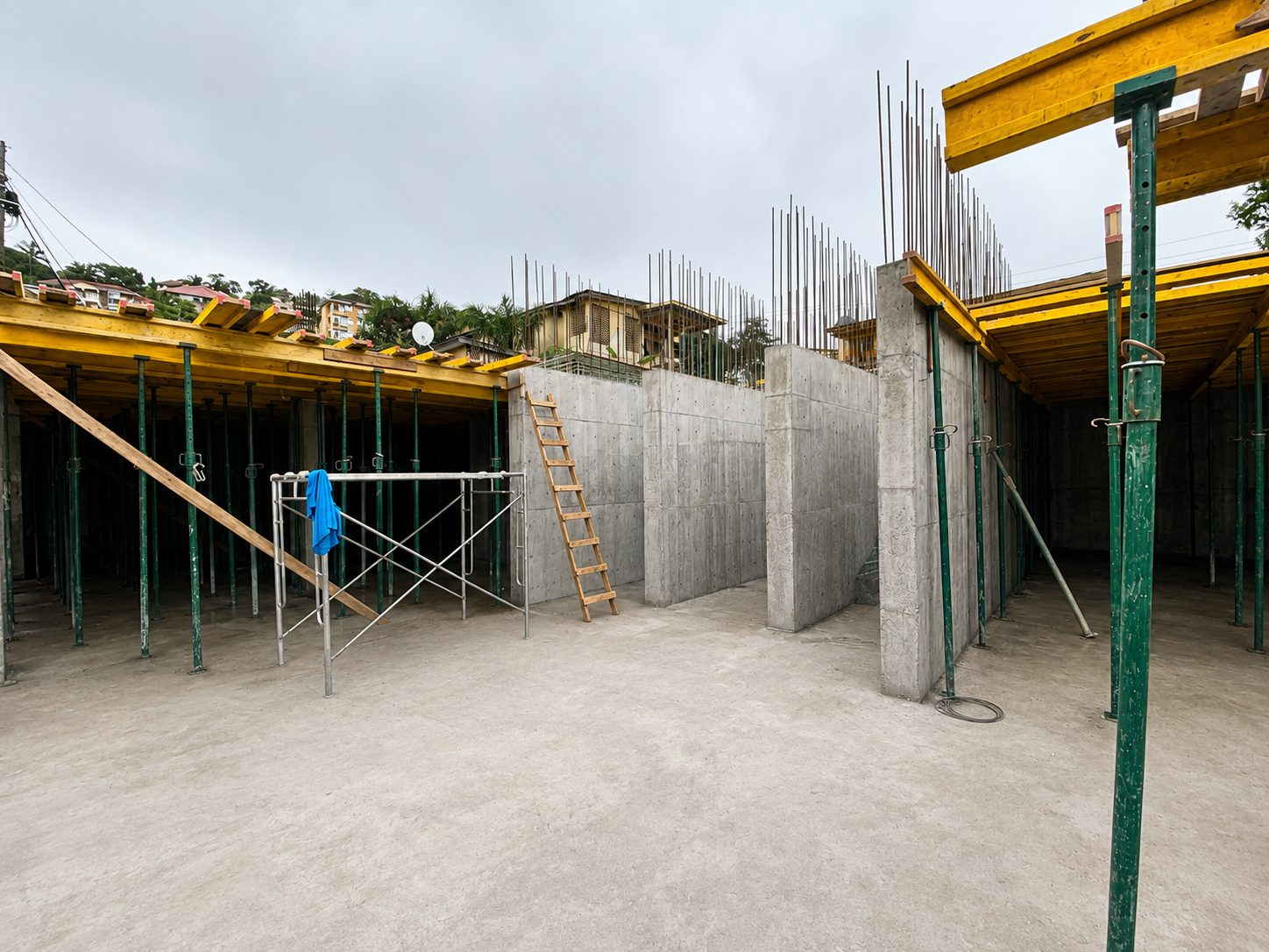 Concrete structural walls and frame rising on a hillside development