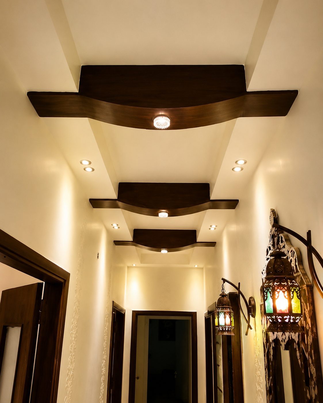 Corridor with sculpted timber ceiling features and traditional lanterns
