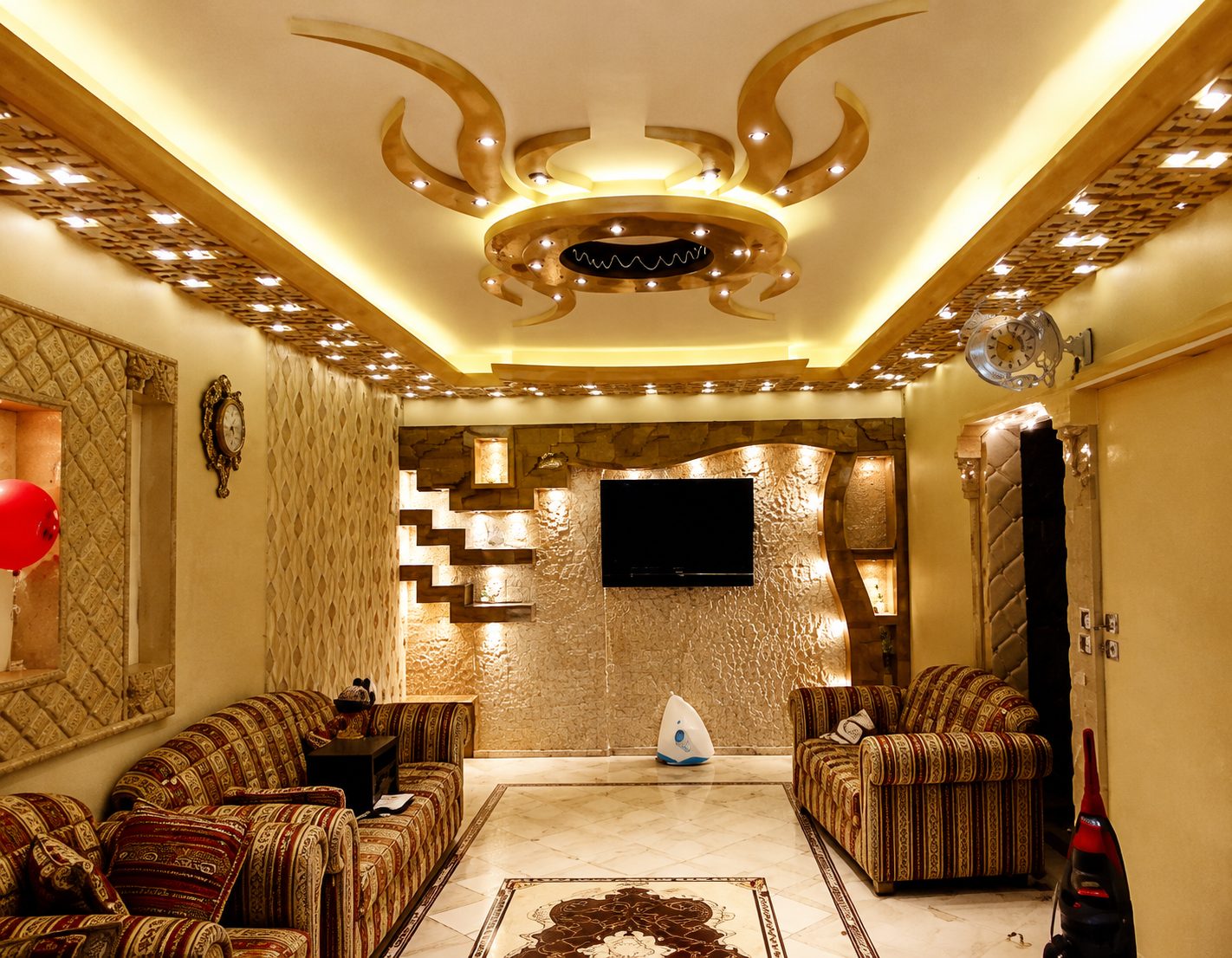 Ornate residential living room with backlit decorative ceiling